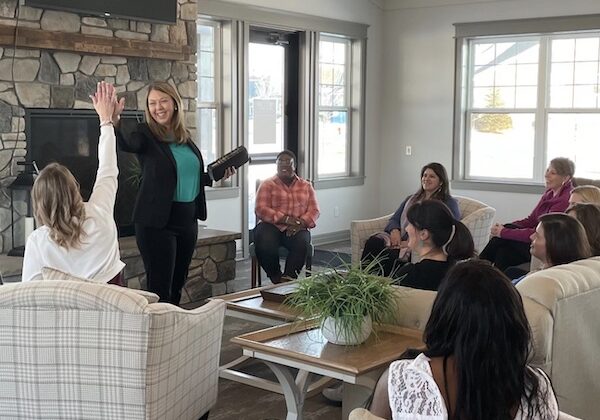 Jenny in a training session giving a high-five to woman attendee with 9 Christian Business Women